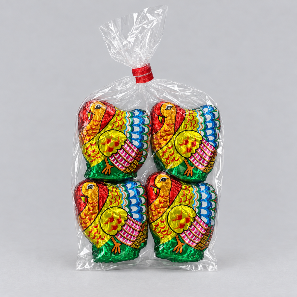 Clear bag of four foil-wrapped chocolate turkeys tied with a red twist tie